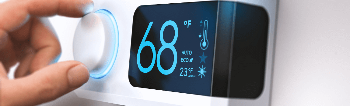 hand turning dial on thermostat