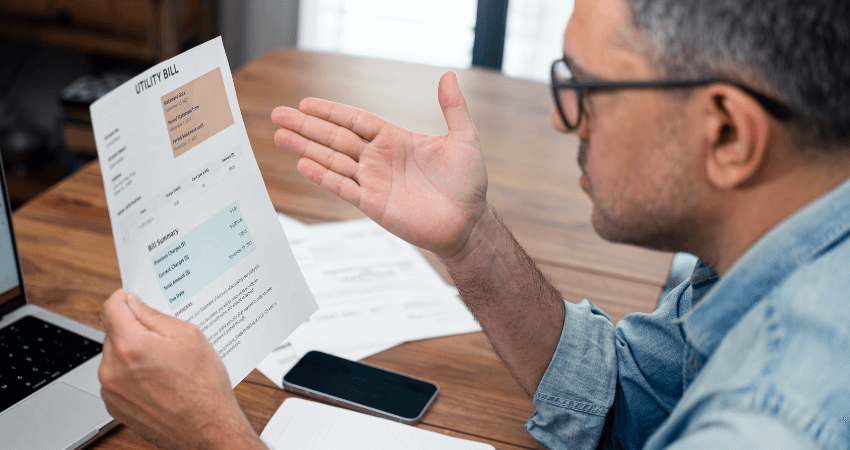 man looking at high utility bill